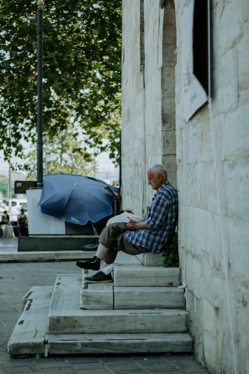 a man sitting on the steps of a building