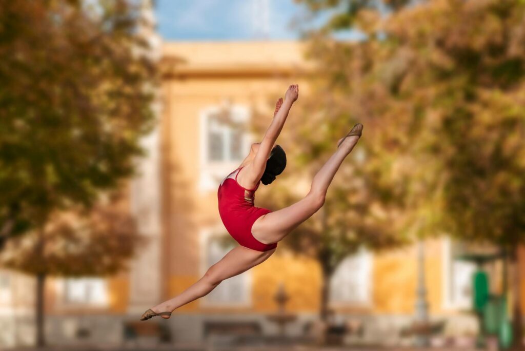 energetic female dancer in mid air split