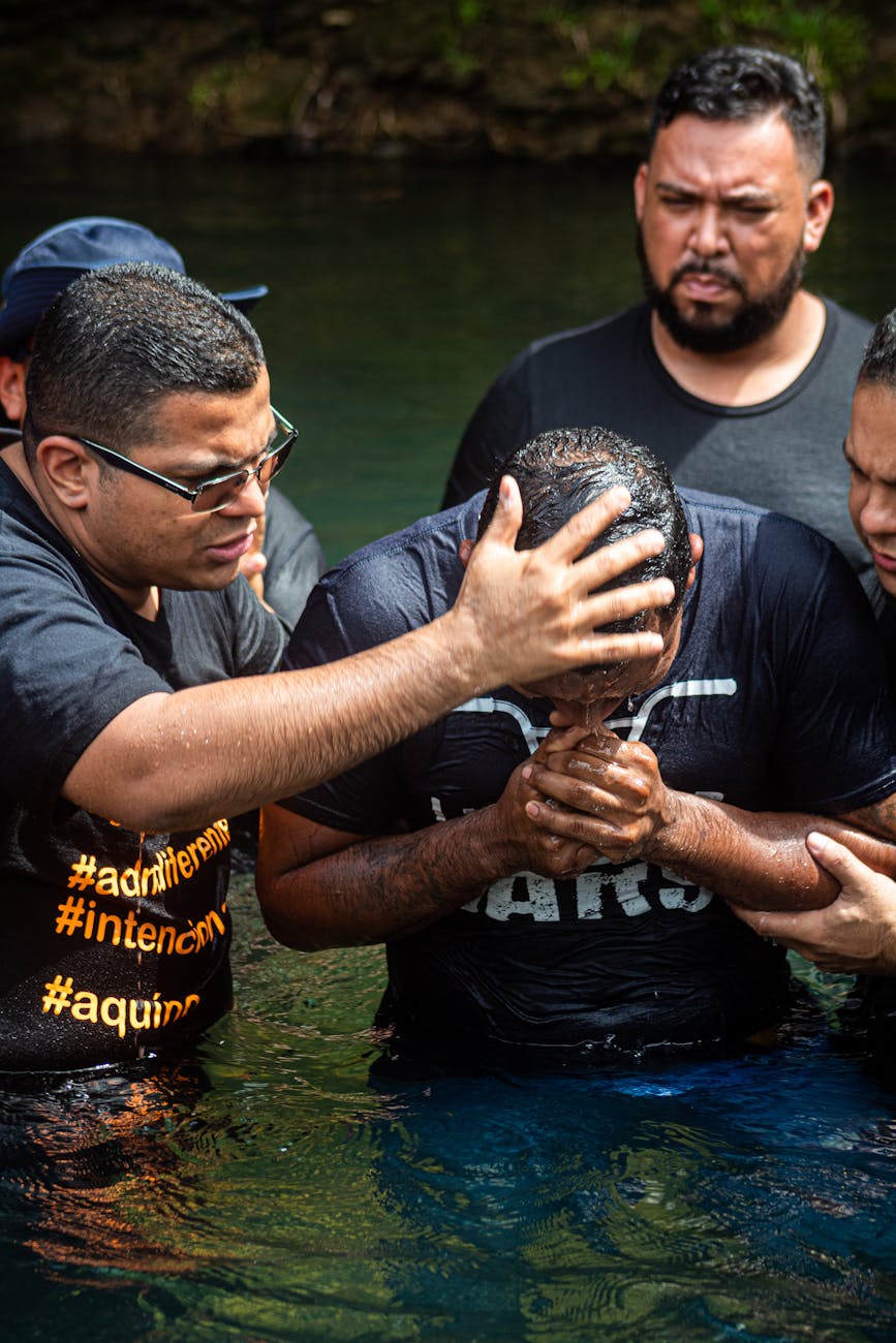 a pastor baptizing a man in a body of water