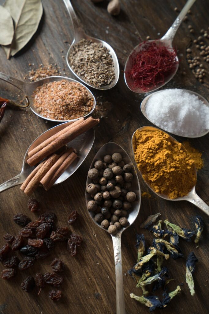 spices and herbs on spoons